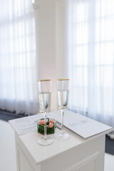 champagne glasses on the table near the arch of the wedding ceremony