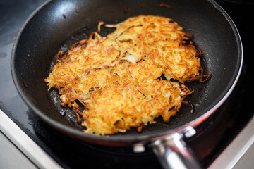Homemade potato pancakes fried in hot oil.