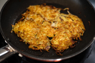 Homemade potato pancakes fried in hot oil.