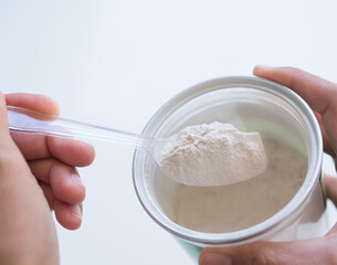 Banan Raw Powder,Banana Flour on Spoon ,Finger Make Flour Banana on white Background,Traditional Herb in Asian Thailand,Vegetable Food  nature for Diet and Treat Gastritis.