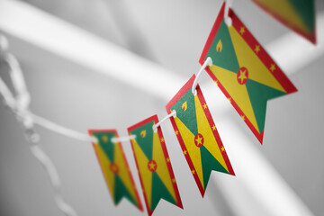 A garland of Grenada national flags on an abstract blurred background