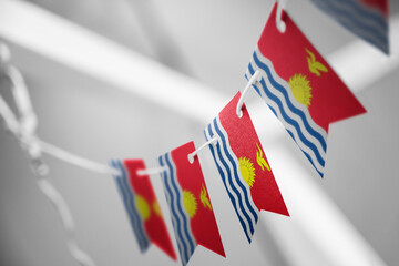 Fototapeta premium A garland of Kiribati national flags on an abstract blurred background