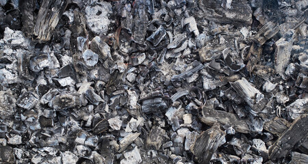 Burned wood texture. Black background, Details on the surface of charcoal, burnt wood texture,...
