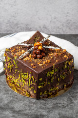 Chocolate and pistachio cake on a dark background. Birthday or celebration cake. close up
