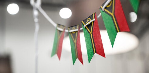 A garland of Vanuatu national flags on an abstract blurred background