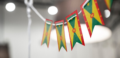 A garland of Grenada national flags on an abstract blurred background