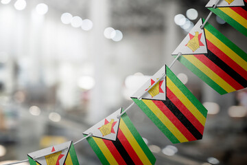 A garland of Zimbabwe national flags on an abstract blurred background