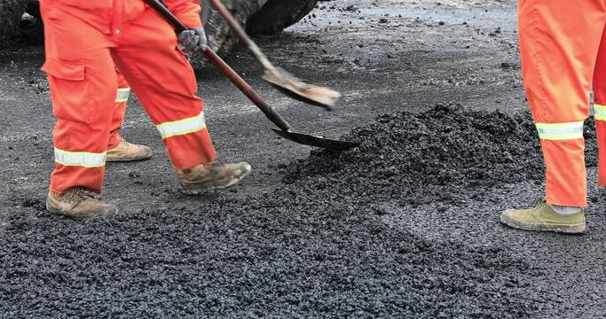 Road workers are laying new asphalt road