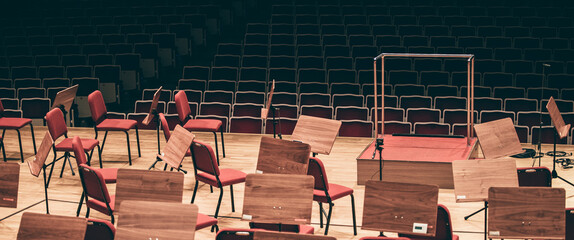 Indoor concert background abstract people performing music instruments in symphony orchestra