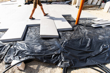 Insulation of the foundation with polystyrene foam plates. Preparation for installation work using...