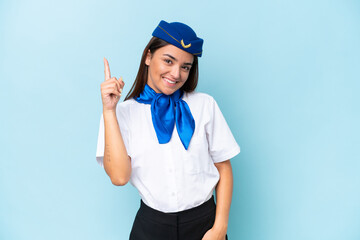Airplane stewardess caucasian woman isolated on blue background showing and lifting a finger in sign of the best