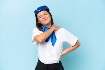 Airplane stewardess caucasian woman isolated on blue background suffering from pain in shoulder for having made an effort