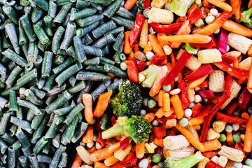 Frozen vegetables on the counter in the store. Assortment of prepared foods in the freezer. Close-up