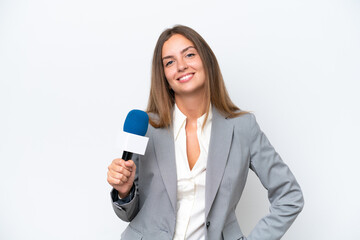 Young TV presenter caucasian woman isolated on white background posing with arms at hip and smiling