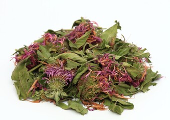 Heap of dried monarda, lat. Monarda didyma, smelling like bergamot, on white background. Fragrant...