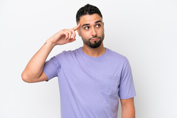 Young Arab handsome man isolated on white background making the gesture of madness putting finger...
