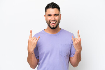 Young Arab handsome man isolated on white background making horn gesture