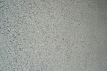 Gray structural painted wallpaper on the wall. Grunge texture background. Grungy painted wall with...