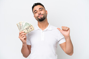 Young Arab man taking a lot of money isolated on white background proud and self-satisfied