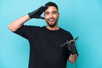 Tattooist Arab man isolated on blue background with surprise expression