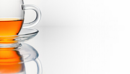 Banner with half a transparent cup of tea with a saucer with reflection on a white background. copyspace. Horizontal. Studio shot. Selective focus.