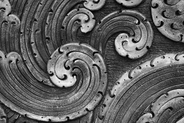 Close up black and white sculpture wall decor design in Wat Rong Suer Ten, Chiang Rai, Thailand beautiful detail interior blue color