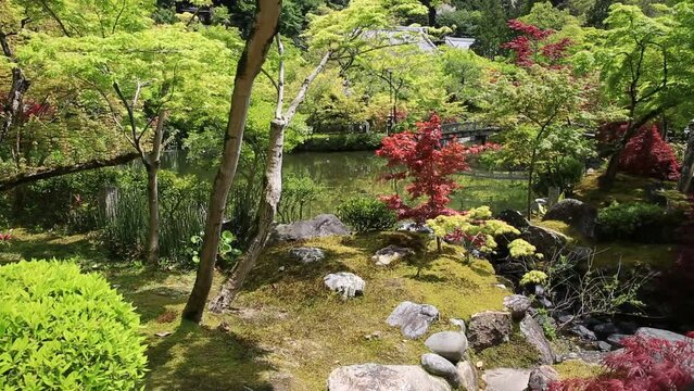 Stone bridge on lake of the maple garden in springtime. Eikan-do Zenrin-ji temple in Kyoto, Japan. Zenrin-ji is the main temple of Jodoshu Buddhism.