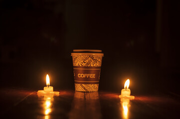 a cup of coffee with candles on the floor