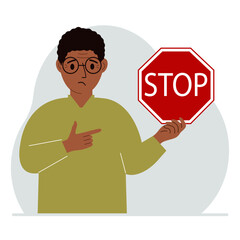 A man holds a red stop sign in his hand.