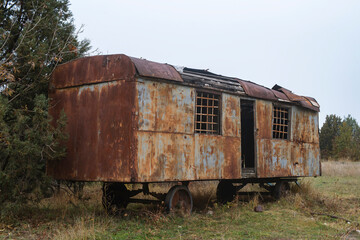 Fototapeta na wymiar Old rusty construction camper, trailer or wagon. Temporary housing for workers.