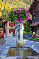 Smal drinking fountain in small village in Swiss Alps