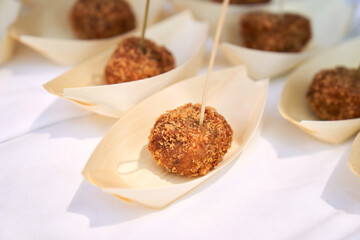 one cocido croquette with a toothpick in single portion