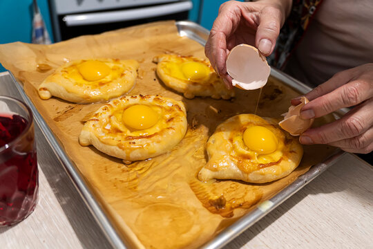 Traditional Georgian bread - khachapuri madjarski with cooker hand.Homemade baking. overhead.Khachapuri with cheese ,georgian khachapuri megruli with cheese, Traditional Georgian pie cooking process