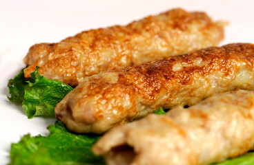 closeup of chicken lula kebab on white background