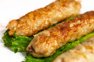 closeup of chicken lula kebab on white background
