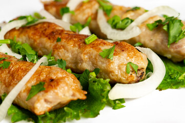 closeup of chicken lula kebab on white background