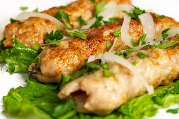 closeup of chicken lula kebab on white background