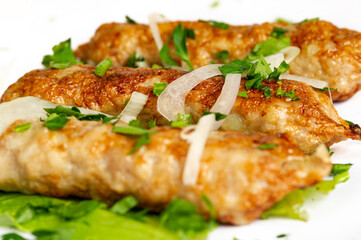 closeup of chicken lula kebab on white background