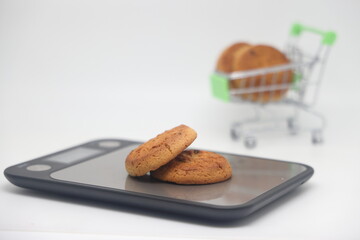 A pack of cookies on an electronic kitchen scale, accurate calorie counting, proper nutrition, diet.