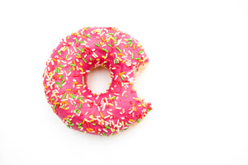 Bitten pink donut isolated on white background