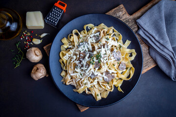 Homemade Italian fettuccine pasta (Fettuccine al Funghi Porcini) with mushroom and cream sauce. Traditional Italian cuisine.