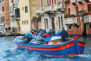 Fototapeta na wymiar Luggage porters in Venice on the Grand Canal, Italy