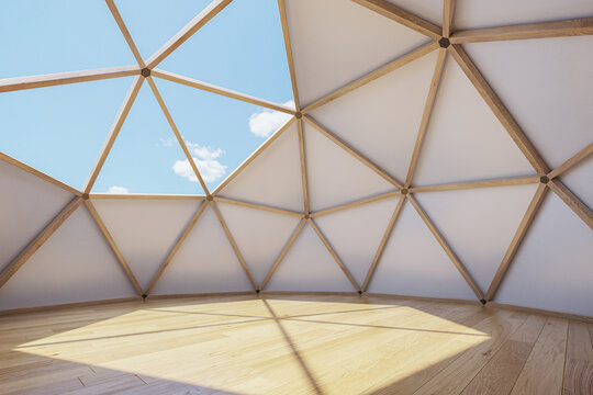 Interior of large geodesic wooden dome tent with window. Empty interior glamping tent.
