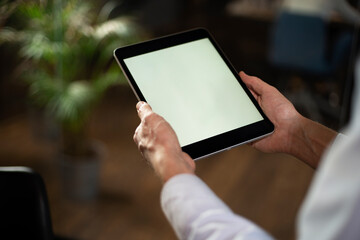 Close up of man using digital tablet