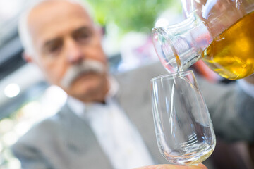 portrait of senior man drinking whisky