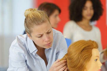 future hairstylist grooming a mannequin wig