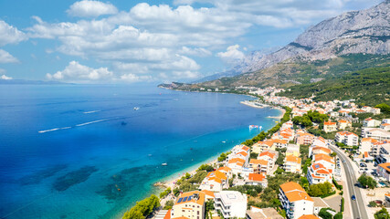 Naklejka premium Panorama of Baska Voda town with harbor against mountains in Makarska riviera, Dalmatia, Croatia