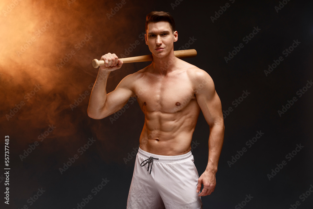 Wall mural image of baseball player with bat posing at the camera with serious face