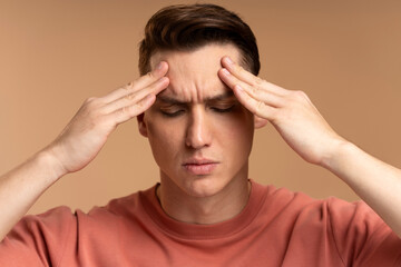Portrait of worried anxious man touching head, feeling pain, suffering migraine problems