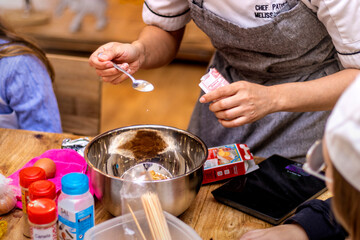 Female pastry chef uses yeast for her cookie recipe.